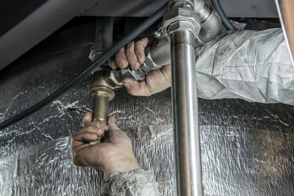 A plumber fixing a pipe