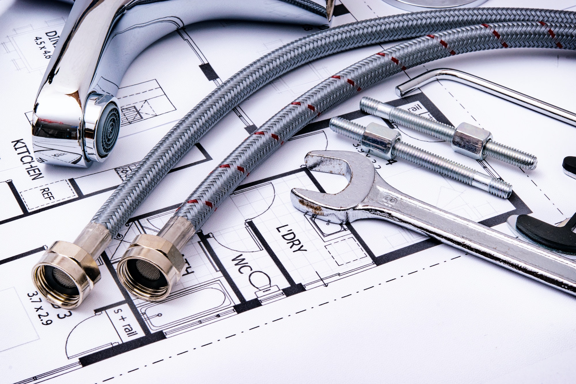 plumbing tools and equipment on a home blueprint