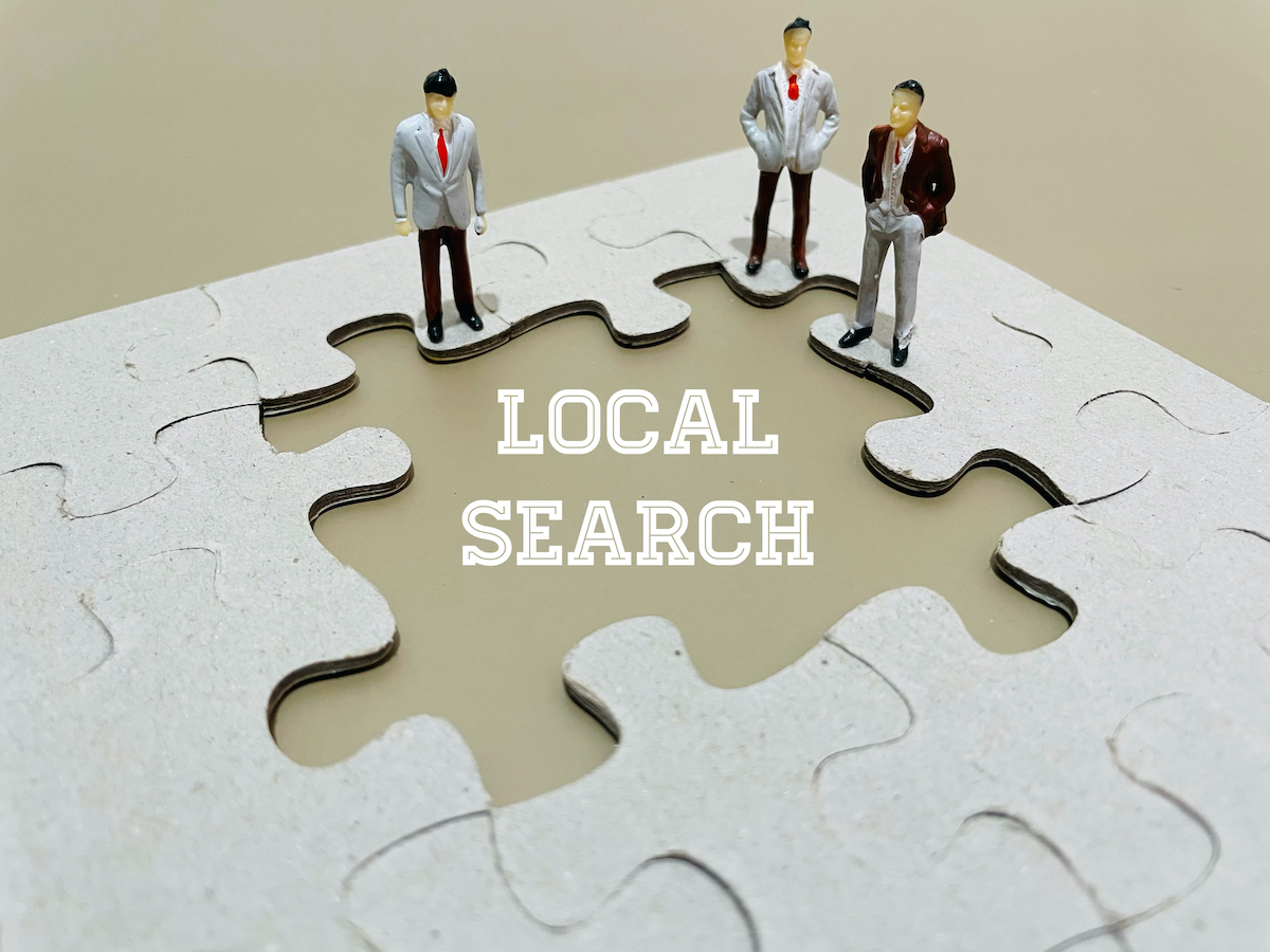 three animated men standing on a puzzle with the words local search