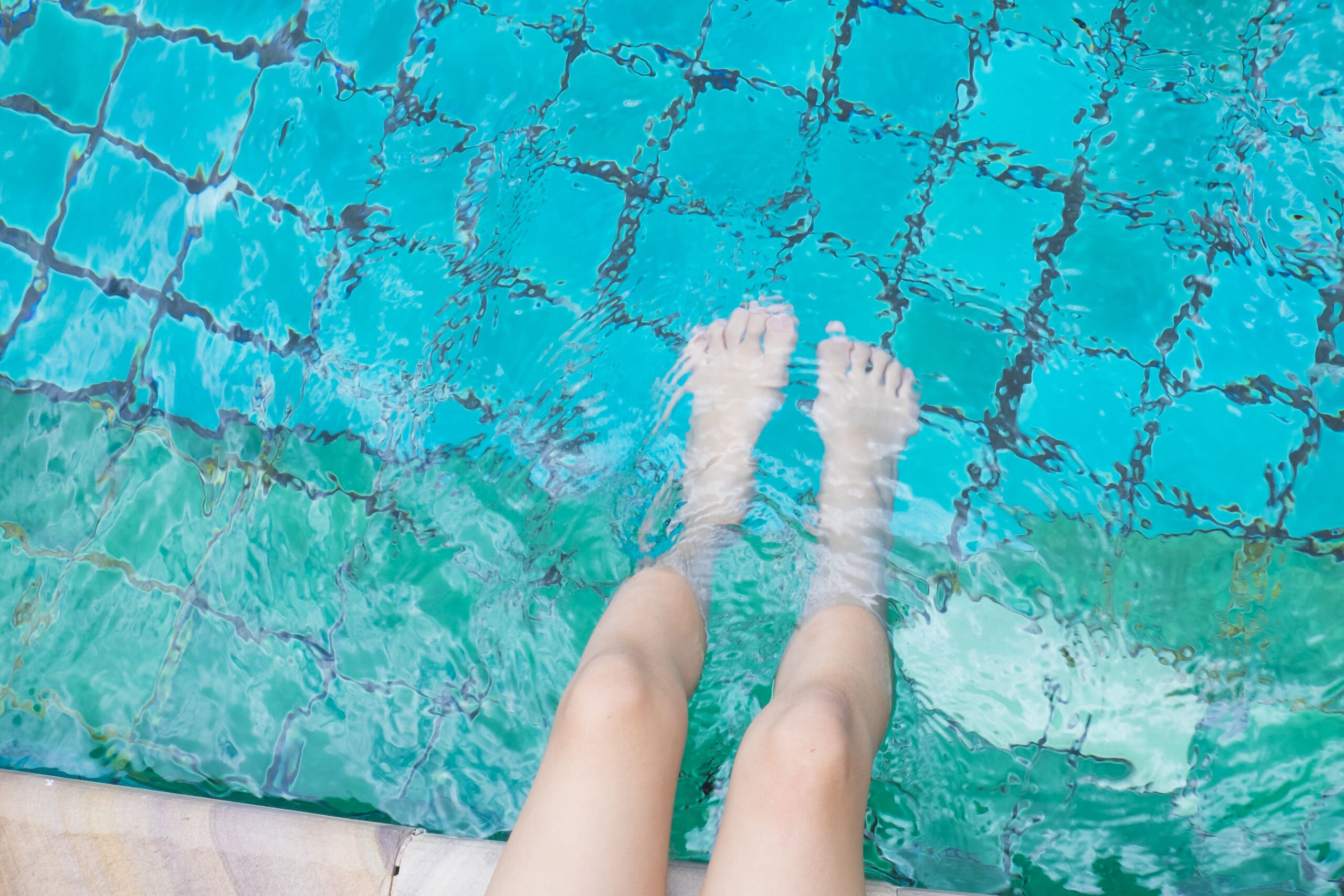 Girl relaxing feet with water pool scaled